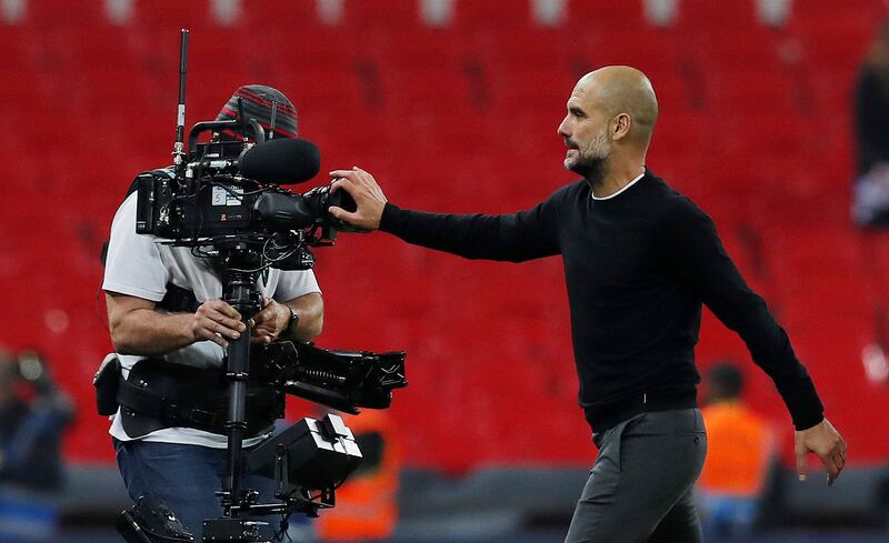 Manchester City manager Pep Guardiola blocks a camera with his hand after the match. Andrew Couldridge / Reuters