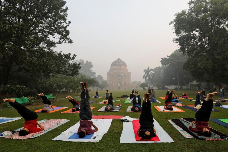 People exercise at a park on a smoggy morning in New Delhi, India. Reuters