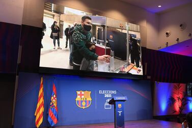 The image of Barcelona's Argentinian forward Lionel Messi voting for FC Barcelona presidential election is displayed at the Camp Nou stadium in Barcelona on March 07, 2021. / AFP / LLUIS GENE