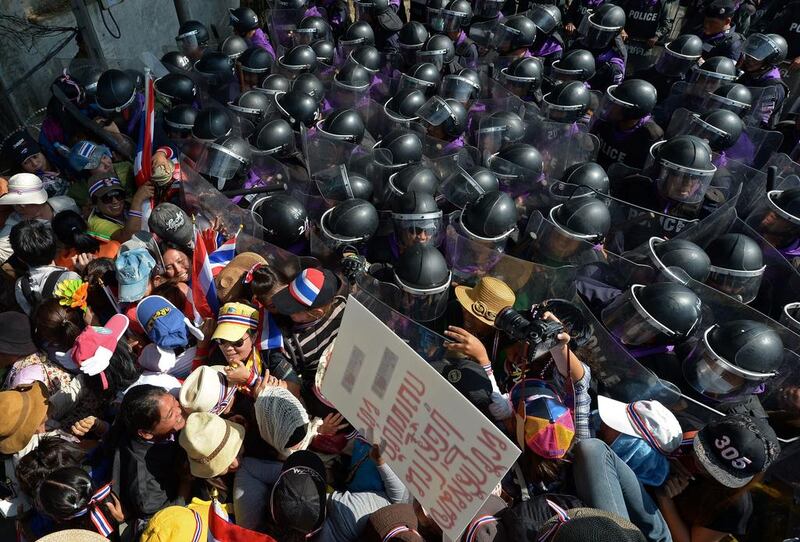 Thai anti-government protesters battle with riot policemen during a rally outside the Bangkok home of Prime Minister Yingluck Shinawatra. Pornchai Kittiwongsakul / AFP



