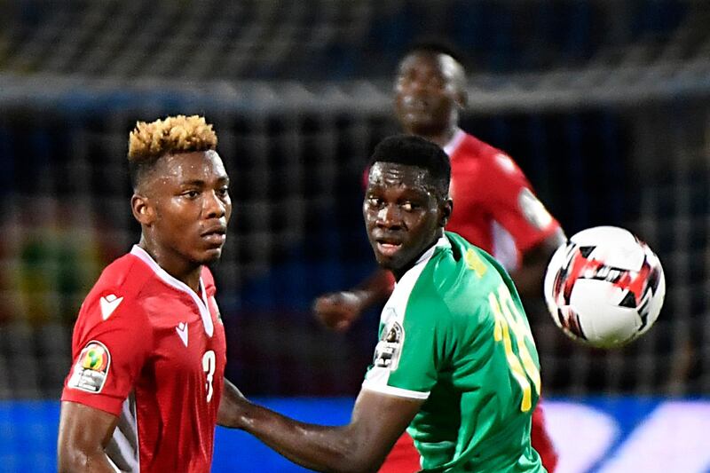 Kenya defender Abud Omar Sfantu, left, and Senegal forward Ismaila Sarr look at the ball. AFP