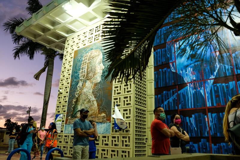 Voters line up at the John F. Kennedy Library, a Miami-Dade County polling station, during the 2020 U.S. presidential election in Miami, Florida.  Reuters