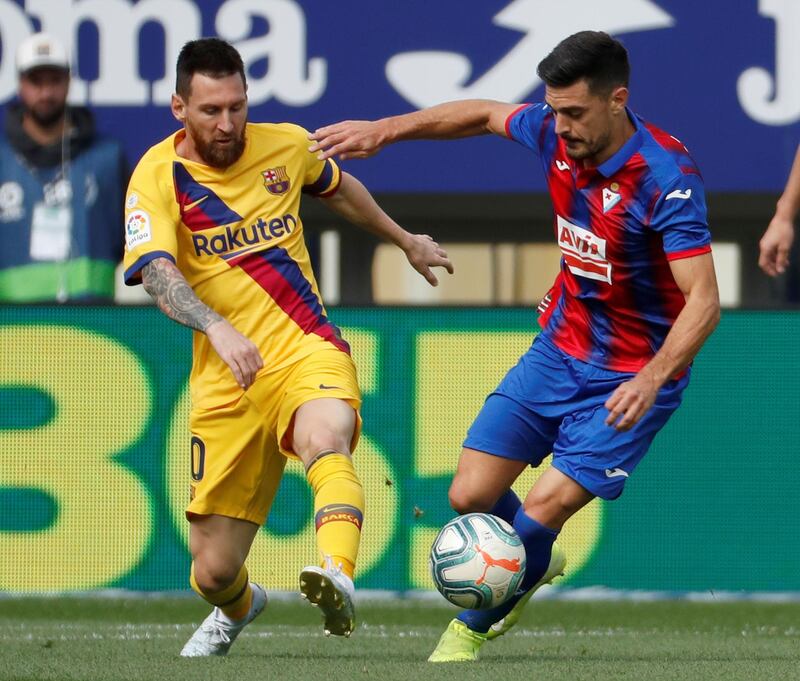 FC Barcelona's Lionel Messi (L) vies for the ball with SD Eibar's Jose Angel (R) during the Spanish LaLiga soccer match between SD Eibar and FC Barcelona played at Ipurua stadium, in Eibar, northern Spain.  EPA