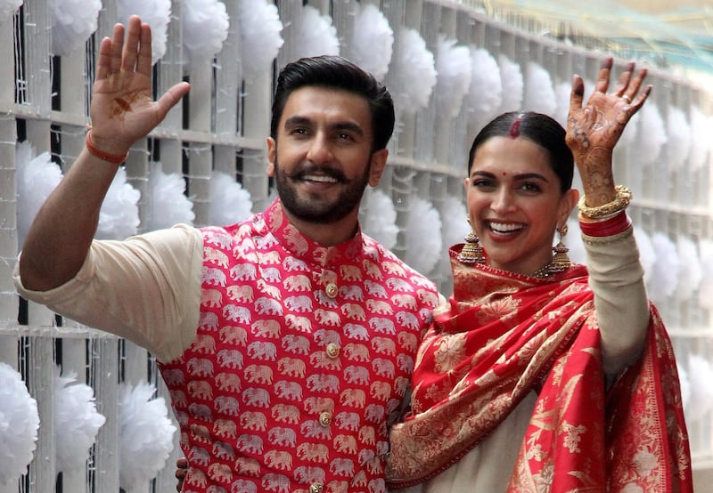 Newly married Bollywood actors Ranveer Singh and Deepika Padukone wave to the media at their residence in Mumbai, India, November 18, 2018. Photo / Reuters