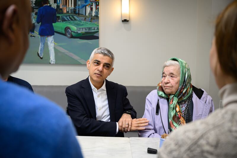 Mr Khan sits with Katarina Gushlenko, 94, as he meets people who have experienced unfair treatment from private landlords, during the launch of his New Deal for Renters in London policy at a coffee shop in the capital. Getty Images