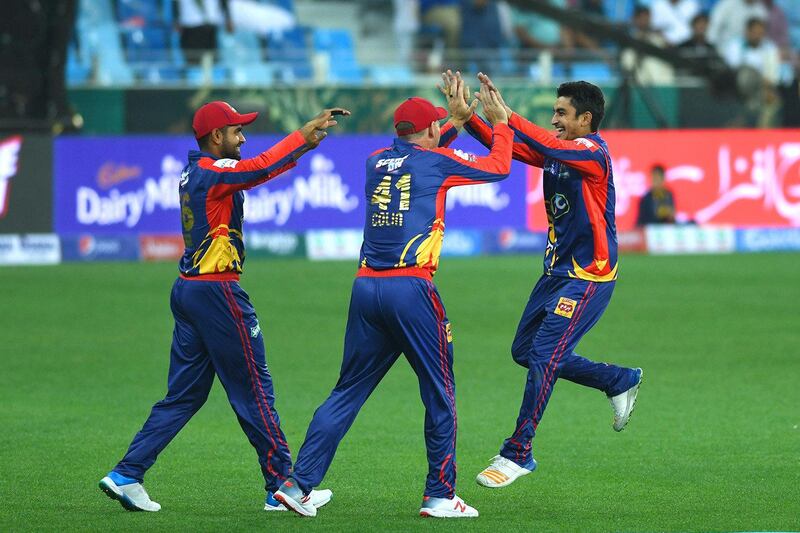 Karachi Kings players celebrate the dismissal of a Lahore Qalandars batsman.
