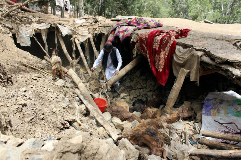 An Afghan villager collects his belongings from under the rubble of his home that was destroyed in an earthquake in the Spera District of the southwestern part of Khost Province, Afghanistan. AP