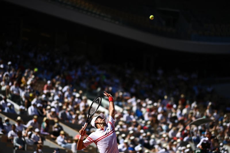 Novak Djokovic serves to Stefanos Tsitsipas during the French Open final. AFP