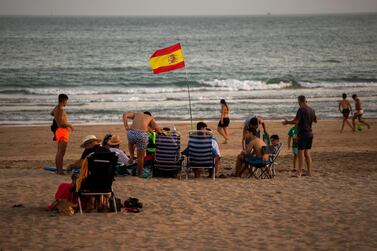 A Spanish flag waves on the beach in Cadiz province. AP