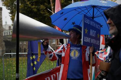 Anti-Brexit remain in the European Union supporter Steve Bray shouts as he protests opposite the Houses of Parliament in London, Thursday, Oct. 24, 2019.  Britain's Prime Minister Boris Johnson won Parliament's backing for his exit deal on Wednesday, but then lost a key vote on its timing, effectively guaranteeing that Brexit won't happen on the scheduled date of Oct. 31.  (AP Photo/Matt Dunham)