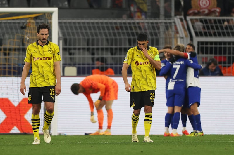 Mats Hummels after his own goal while Atletico players celebrate in the background. Reuters