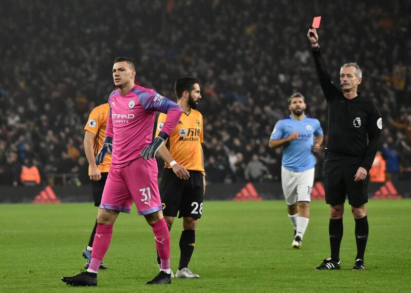 Manchester City's goalkeeper Ederson receives a red card from referee Martin Atkinson. AP
