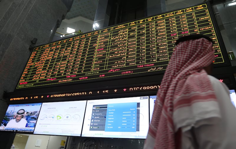 epa06772374 An investor follows the stock market developments on a screen board at the Abu Dhabi Securities Exchange (ADX) in Abu Dhabi, United Arab Emirates, 30 May 2018.  EPA/ALI HAIDER