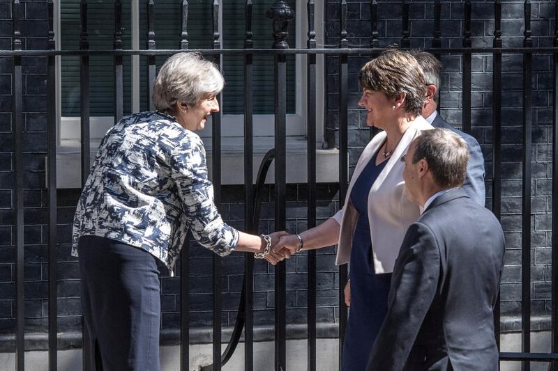 LONDON, ENGLAND - JUNE 26:  Britain's Prime Minister, Theresa May (L), greets Arlene Foster, the leader of Northern Ireland's Democratic Unionist Party (C), deputy leader of the Democratic Unionist Party, Nigel Dodds (R) and DUP MP Jeffrey Donaldson (at rear) as they arrive in Downing Street on June 26, 2017 in London, England. Mrs Foster has said a deal between her party and the Conservatives to support a minority government is close.  (Photo by Carl Court/Getty Images)