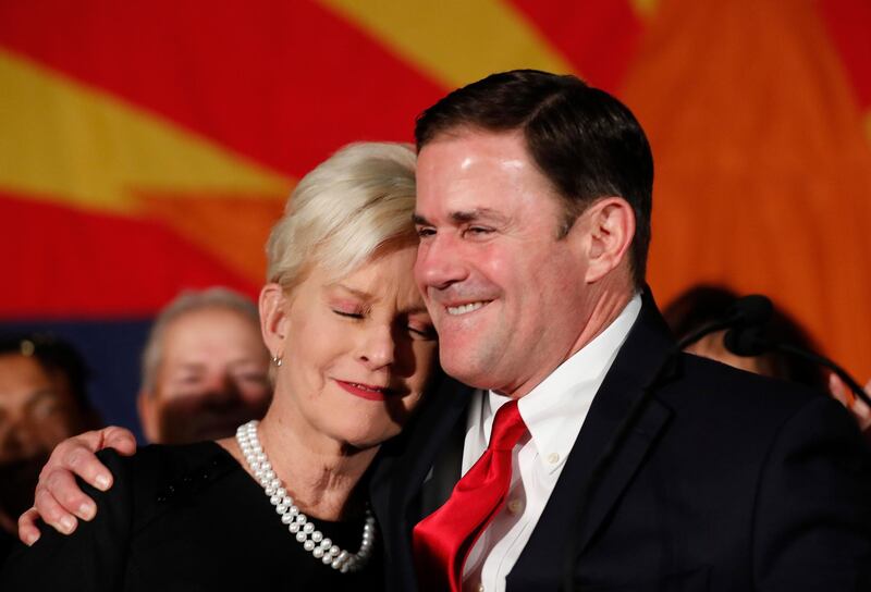 Republican Arizona Governor Doug Ducey embraces Cindy McCain, wife of the late US Senator John McCain while speaking to supporters at the GOP party in Arizona. AP