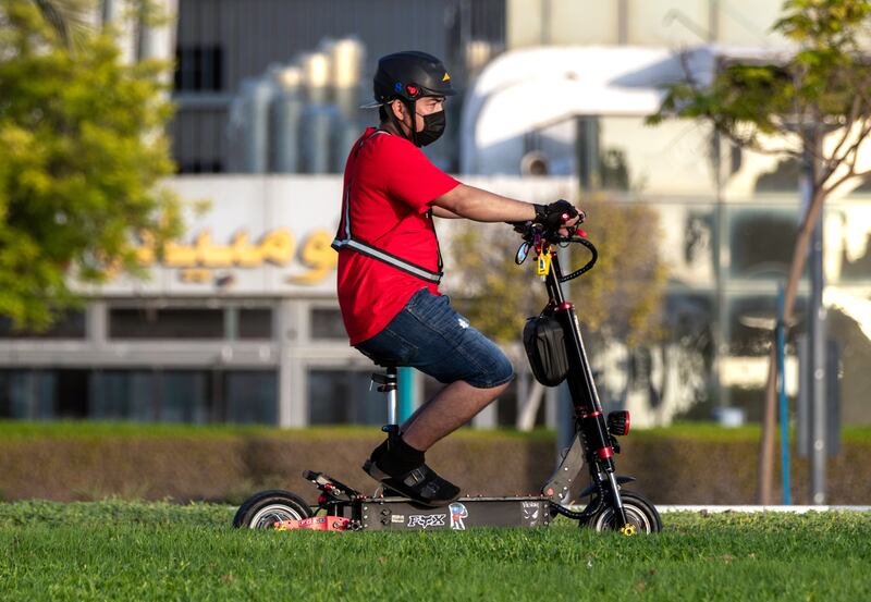 Modified e-scooters with seats have become a common sight. Abu Dhabi authorities have banned such models amid concerns over the effect on the rider's balance. Victor Besa / The National