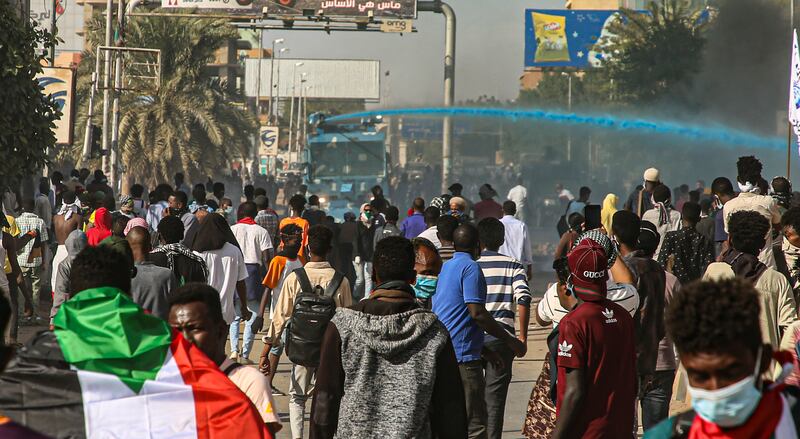 Security forces use water cannon to disperse protesters.  EPA