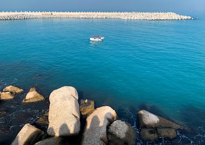 A fishing boat is seen near a newly constructed concrete barrier constructed to protect Alexandria's shoreline. Reuters 