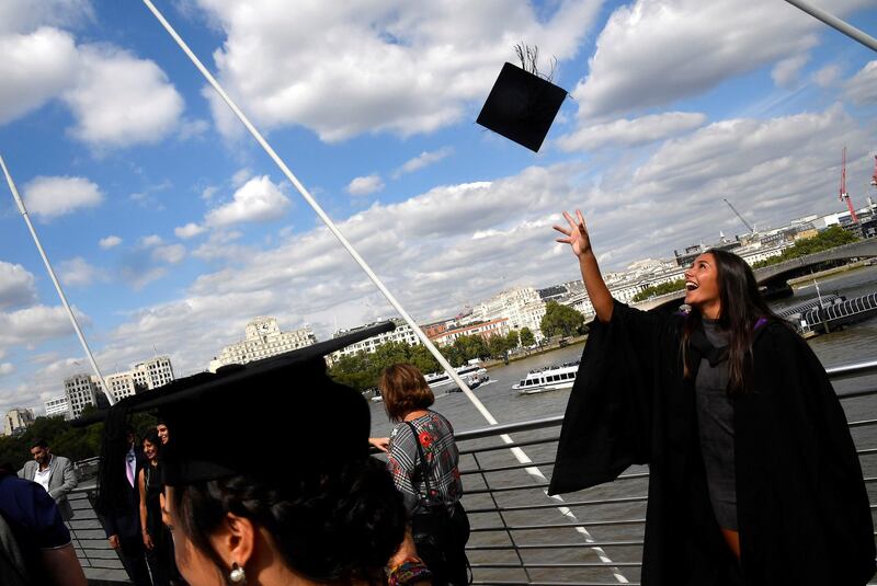 Students from University College London (UCL) celebrate with friends and family following a graduation ceremony on the Southbank in London, Britain, September 6, 2018. REUTERS/Toby Melville