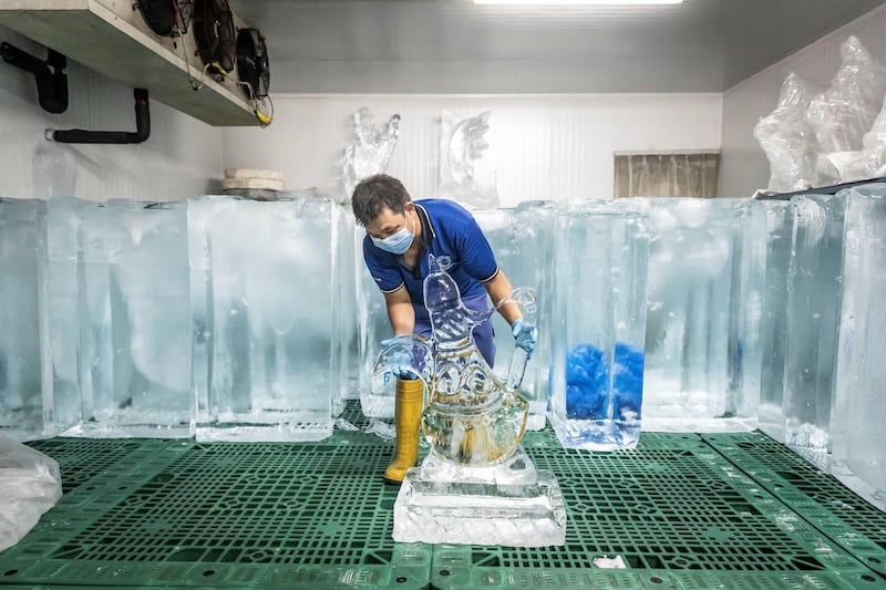 PHOTO PROJECT: ICE FACTORY. A visit to the Gulf Ice Factory & Modern Ice Factory (G&M Ice) located in Dubai Investment Park on June 15th, 2021. The manufacturing of Crystal Clear Ice Blocks whereby a  100cm x 60 cm x 30 cm, 200 kg perfectly clear block of ice is produced over the course of a week. This is accomplished by keeping the water in motion using air while it is slowly frozen. This causes the forming ice to form without traping air inside itself, giving it a clear see through finish that is then used to creat ice sculptures. These ice sculptures can anywhere from 6-12 days before fully melted. They are kept in seperate refrigiration rooms that are set to -18C.
The company first started producing ice in the UAE in 1976 in the emirate of Sharjah followed by setting up of multiple units like Modern Ice Factory in 1989, Quality Ice Distribution Office in 1992, Tube Ice Production in 2000 & its latest production facility at Dubai Investments Park launched in May 2008. They are the largest ice producer in the UAE. 
Antonie Robertson / The National.
Reporter: Antonie Robertson for National