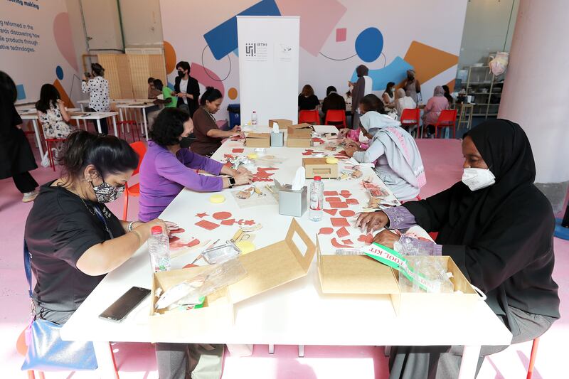 Participants making craft items in the art workshop on the opening day of Dubai Design Week