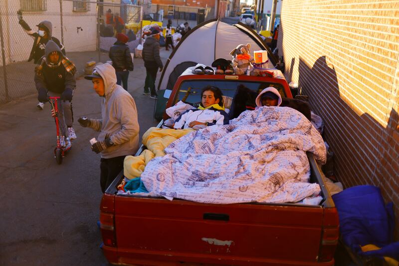 Migrants rest in the back of a truck. Reuters