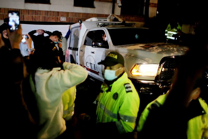 Colombian investigators leaves the hotel where Hawkins was found dead. AP