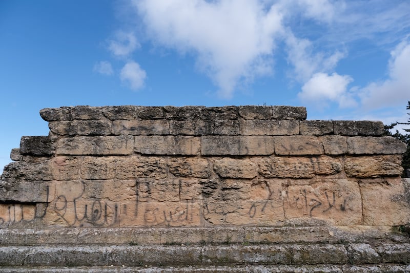 The ruins of the ancient Greek city of Cyrene, now known as Shahat, are plastered with graffiti and littered with trash.