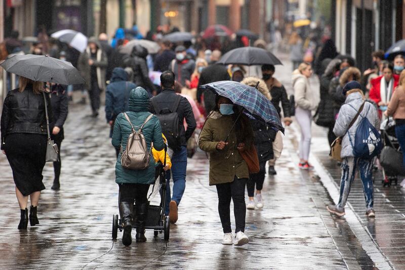 Many people wearing face masks as they move along a main shopping street in Nottingham, England, Tuesday Oct. 27, 2020.  The Nottingham area will move into the Tier 3 highest level of coronavirus restrictions on upcoming Thursday because of a surge in COVID-19.  (Joe Giddens/PA via AP)
