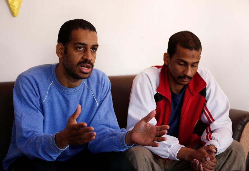 FILE - In this March 30, 2019, file photo, Alexanda Amon Kotey, left, and El Shafee Elsheikh, who were allegedly among four British jihadis who made up a brutal Islamic State cell dubbed "The Beatles," speak during an interview with The Associated Press at a security center in Kobani, Syria. (AP Photo/Hussein Malla, File)