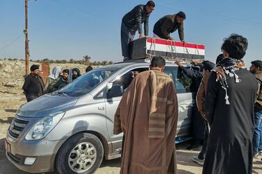 Mourners arrive in a funeral convoy transporting the body of a Hashed al-Shaabi fighter for burial in the southern city of Nasiriyah on January 24, 2021, after he was killed in an ISIS ambush in Tikrit. AFP