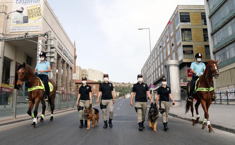 Ankara's mounted police unit officers patrol with dogs the streets in the Ulus district in Ankara, Turkey.  AFP