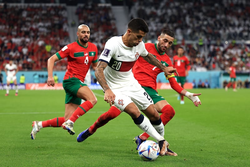 Joao Cancelo of Portugal  controls the ball against Hakim Ziyech of Morocco at the Qatar 2022 World Cup. Getty 
