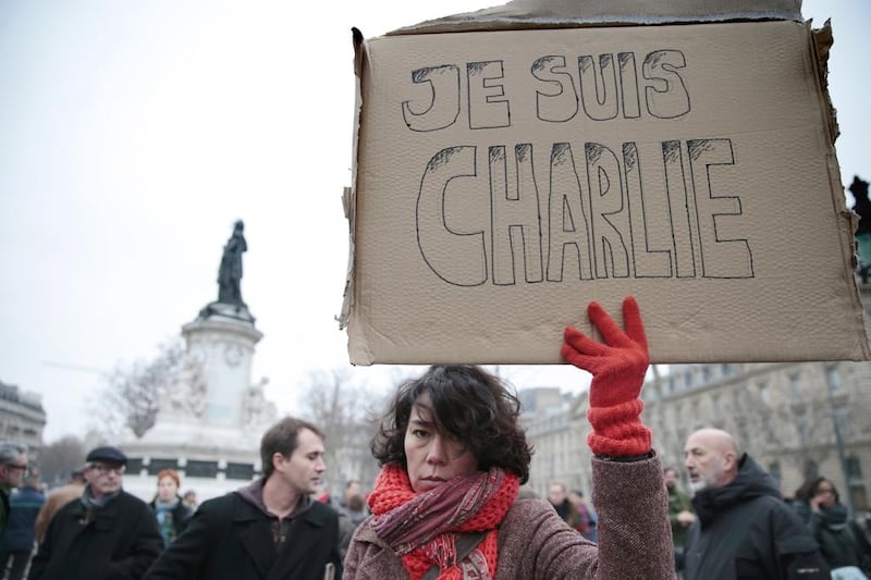 A woman holds up a placard that reads in French, "I am Charlie" a in  the Place de la Republique in Paris in January following the attack on the offices of Charlie Hebdo.  Joel Saget / AFP Photo