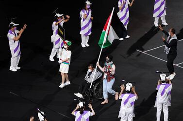 TOKYO, JAPAN - AUGUST 24: Flag bearer Husam F A Azzam of Team Palestine leads his delegation in the parade of athletes during the opening ceremony of the Tokyo 2020 Paralympic Games at the Olympic Stadium on August 24, 2021 in Tokyo, Japan. (Photo by Carmen Mandato / Getty Images)
