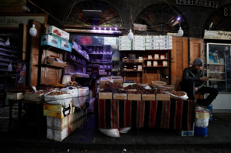 A shopkeeper waits for customers in Damascus