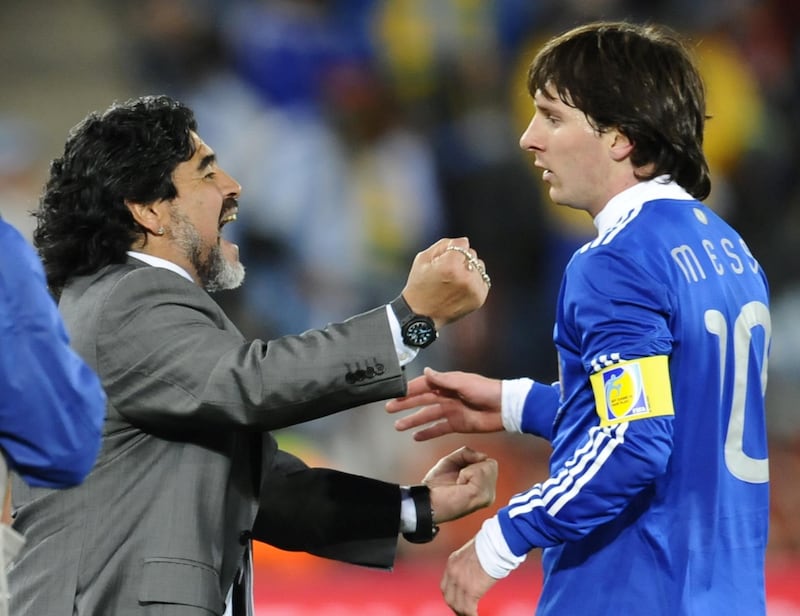 Argentina's striker Lionel Messi (R) celebrates with Argentina's coach Diego Maradona at the end of the Group B first round 2010 World Cup football match Greece vs Argentina on June 22, 2010 at Peter Mokaba stadium in Polokwane. Argentina defeated Greece 2-0. NO PUSH TO MOBILE / MOBILE USE SOLELY WITHIN EDITORIAL ARTICLE -      AFP PHOTO / DANIEL GARCIA (Photo by DANIEL GARCIA / AFP)