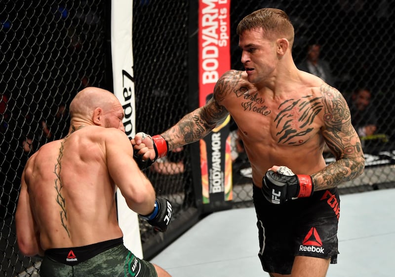 Jan 23, 2021; Abu Dhabi, United Arab Emirates; Dustin Poirier punches Conor McGregor of Ireland in a lightweight fight during the UFC 257 event inside Etihad Arena on UFC Fight Island.  Mandatory Credit: Jeff Bottari/Handout Photo via USA TODAY Sports