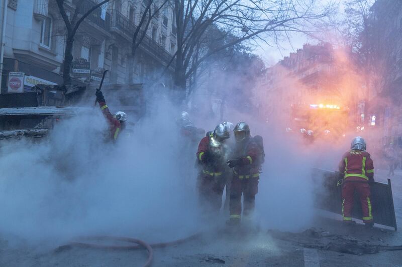 Firefighters put out a fire during a protest in Paris, France. Getty Images