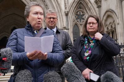 Cathy Gardner (left) and Fay Harris (right), whose fathers died from Covid-19, speaking outside the Royal Courts of Justice in central London. PA