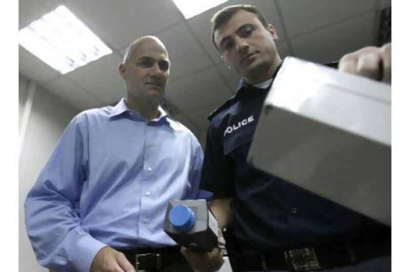 Teimuraz Kupatadze, a Georgian police chief, demonstrates radiation detection equipment to Thomas D’Agostino, head of the US department of energy’s National Nuclear Security Administration.