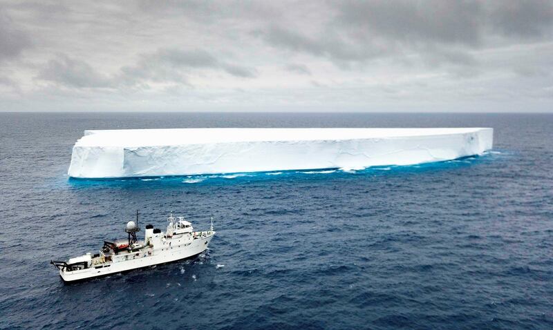 A boat sails past an Iceberg in the Southern Ocean.  Courtesy: The Five Deeps Expedition