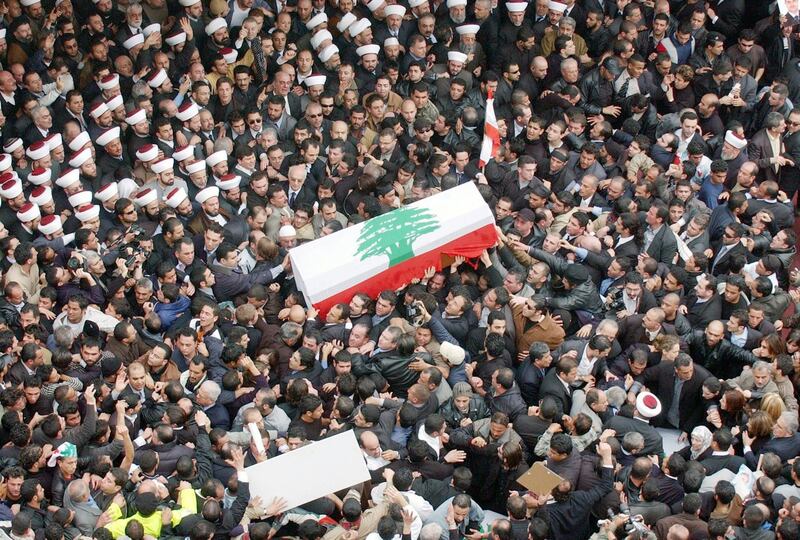 epa08611228 (FILE) - Draped with the Lebanese national flag, the coffin of assassinated former Lebanese  prime minister Rafiq Hariri is carried through a crowds of hundreds of thousands to his final resting place in central Beirut, Lebanon, 16 February 2005 (Reissued 18 August 2020). On 18 August 2020, Judges of the UN-backed Special Tribunal for Lebanon in the Netherlands found Salim Ayyash, a member of the Hezbollah militant group, guilty of involvement in the assassination of former Lebanese Prime Minister Rafic Hariri and 21 others on 14 February 2005.  EPA-EFE/WAEL HAMZEH