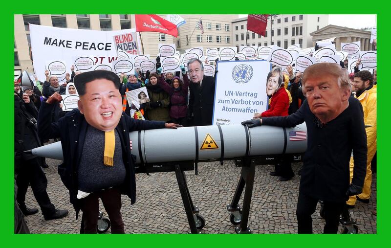 BERLIN, GERMANY - NOVEMBER 18:  An activist with a mask of Kim Jong-un, chairman of the Workers' Party of Korea and supreme leader of North Korea (L), and another with a mask of U.S. President Donald Trump, march with a model of a nuclear rocket during a demonstration against nuclear weapons on November 18, 2017 in Berlin, Germany. About 700 demonstrators protested against the current escalation of threat of nuclear attack between the United States of America and North Korea. The event was organized by peace advocacy organizations including the International Campaign to Abolish Nuclear Weapons (ICAN), which won the Nobel Prize for Peace this year.  (Photo by Adam Berry/Getty Images)***BESTPIX***