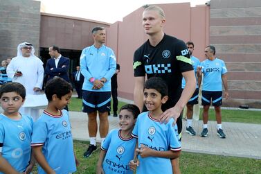 Manchester City and Norway striker Erling Haaland with Jaber and Zayed . Manchester City train in Abu Dhabi at Emirates Palace. Chris Whiteoak / The National