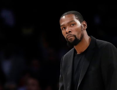 FILE- In this March 10, 2020, file photo, Brooklyn Nets' Kevin Durant watches during the second half of the team's NBA basketball game against the Los Angeles Lakers in Los Angeles. Durant is among the four Brooklyn Nets who have tested positive for the new coronavirus. (AP Photo/Marcio Jose Sanchez, file)