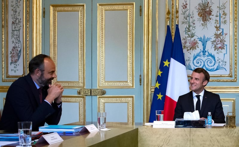 French President Emmanuel Macron, right, speaks with French Prime Minister Edouard Philippe as they attend a meeting with President of Senate Gerard Larche, House speaker Richard Ferrand and President of the Economic, Social and Environmental Council (CESE), Patrick Bernasconi at the Elysee Palace in Paris, Thursday July, 2 2020. (Ian Langsdon, Pool via AP)