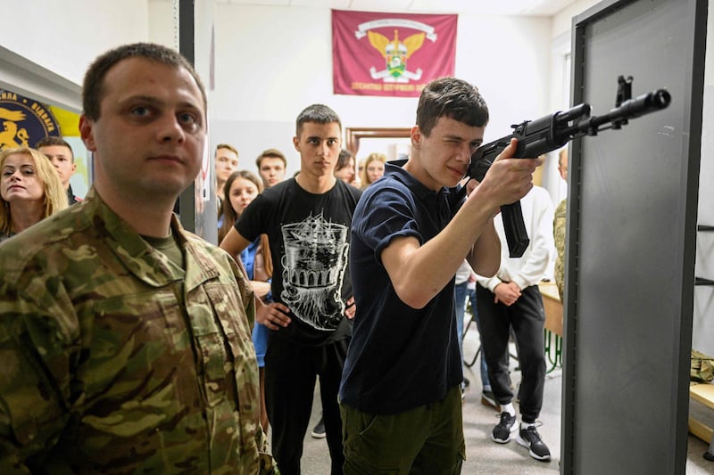 A teenager aims a Kalashnikov AK47 rifle during defence training at a centre for school pupils in Lviv. AFP