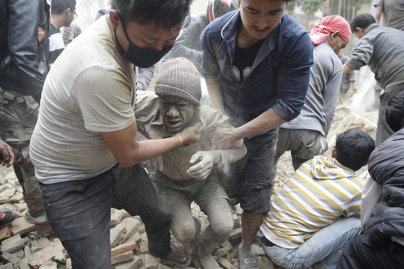 A man is freed from the rubble of a destroyed building after an earthquake hit Nepal, in Kathmandu. A 7.9-magnitude earthquake rocked Nepal destroying buildings in Kathmandu and surrounding areas, with nearly 2,000 expected dead. The epicentre was 80 kilometres northwest of Kathmandu. Narendra Shrestha / EPA