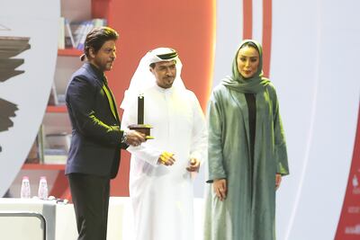 Shah Rukh Khan receives his award at the Sharjah International Book Fair. Pawan Singh / The National 